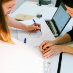 woman in black shirt using macbook pro